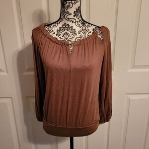 Neutral brown woman's top with‎ gold chain neckline